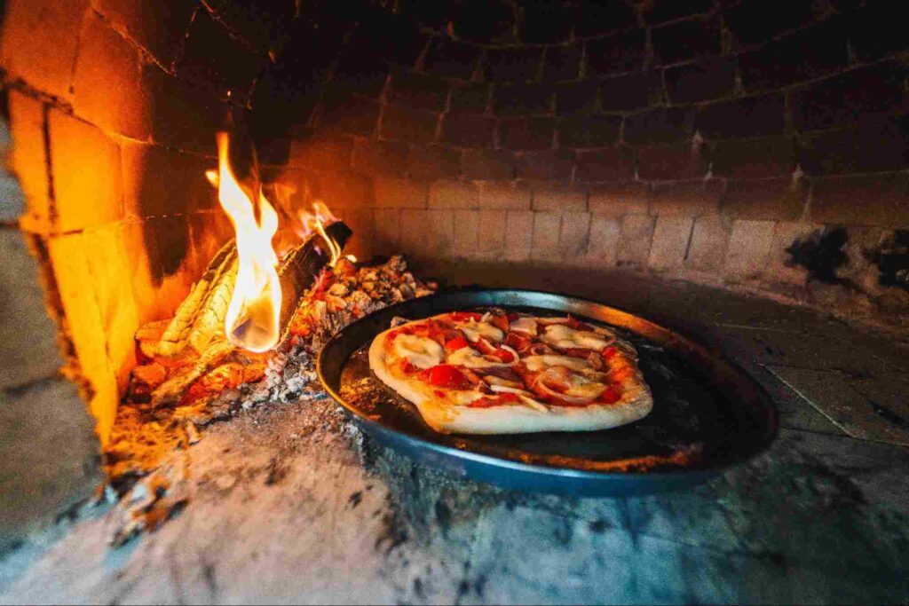 pizza in a wood-fired brick oven