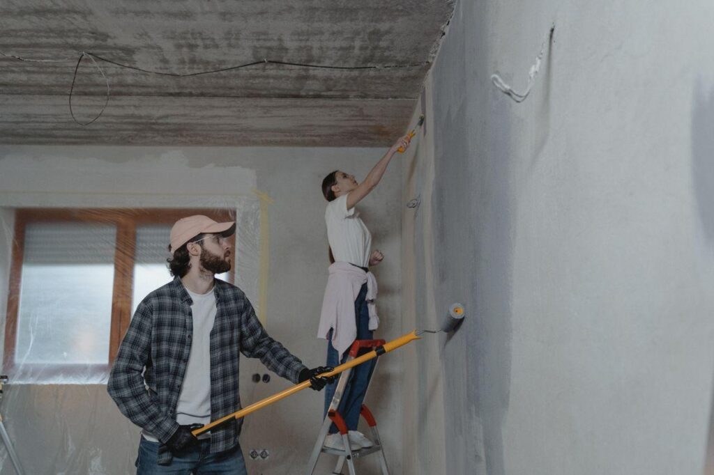 A couple painting a room together