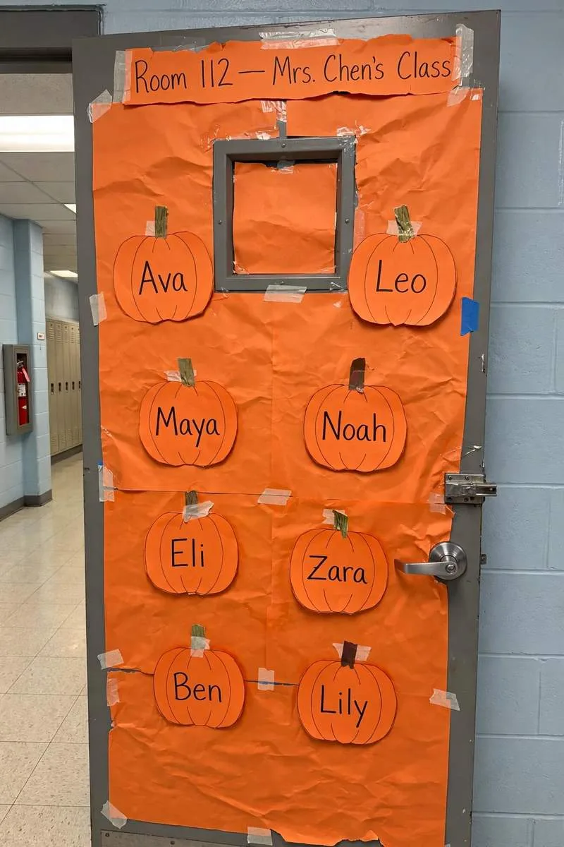 Pumpkin patch classroom door with paper pumpkins and green vines