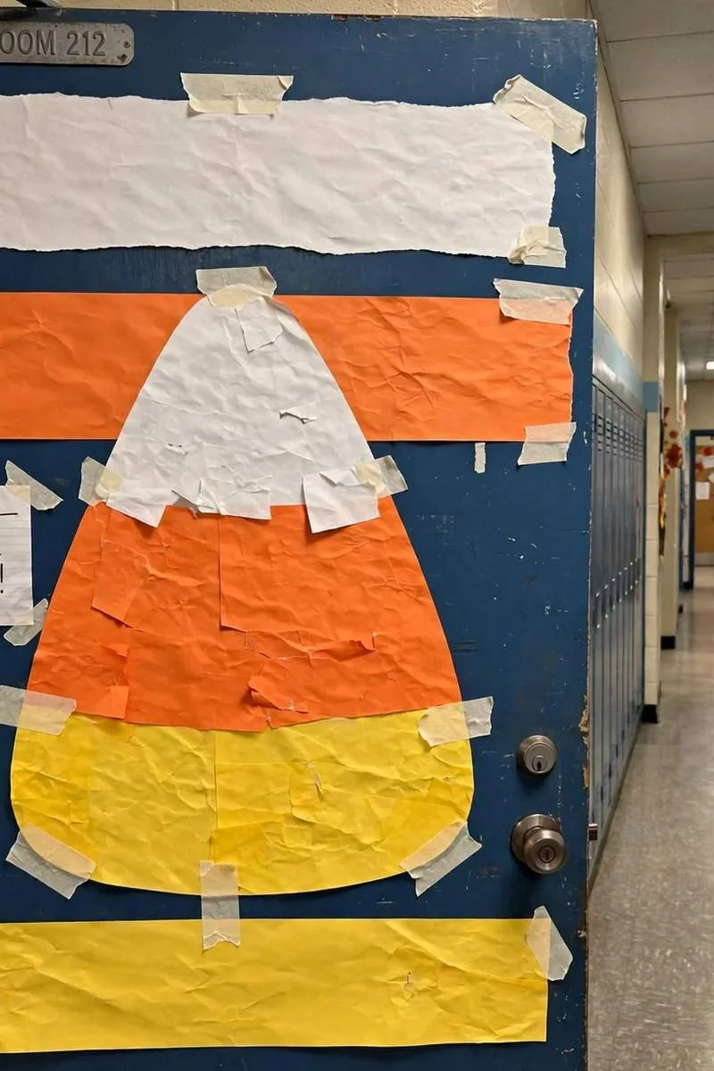 Candy corn classroom door in white, orange and yellow stripes